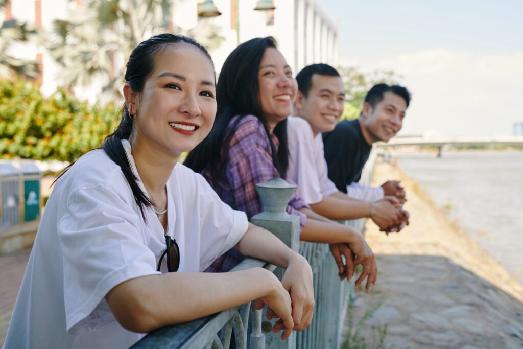 Group of cheerful friends enjoying river view