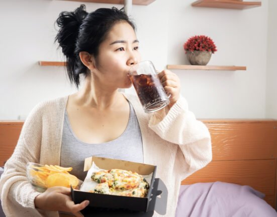 Lazy woman eating junk food hand