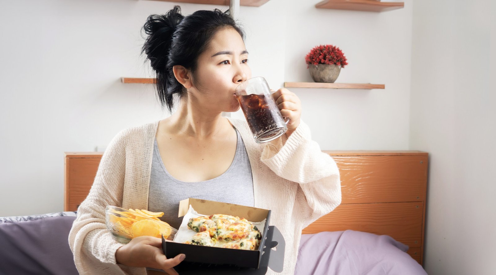 Lazy woman eating junk food hand