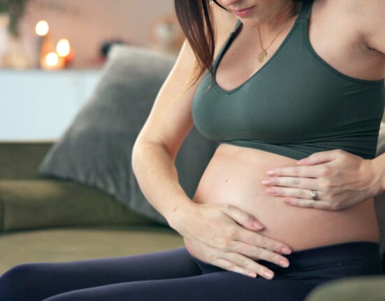 Product skin care hand pregnant woman.