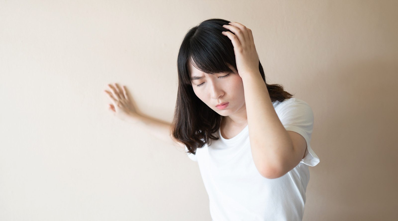 Young Asian female suffering dizziness vertigo.