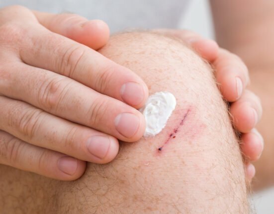 Young adult man finger applying white.
