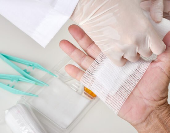 Doctor doing wound dressing care bandaging.
