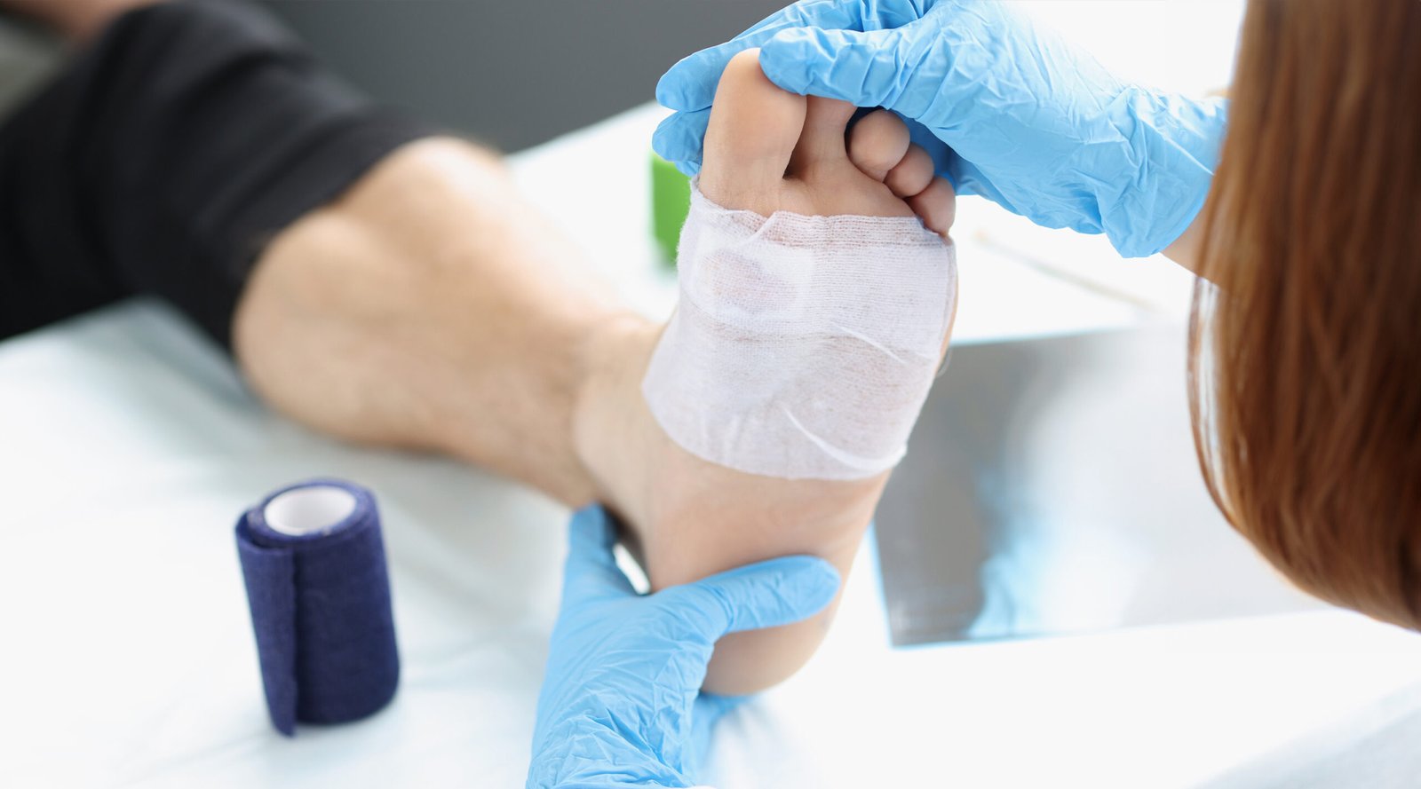 Doctor hand touches examines wound on